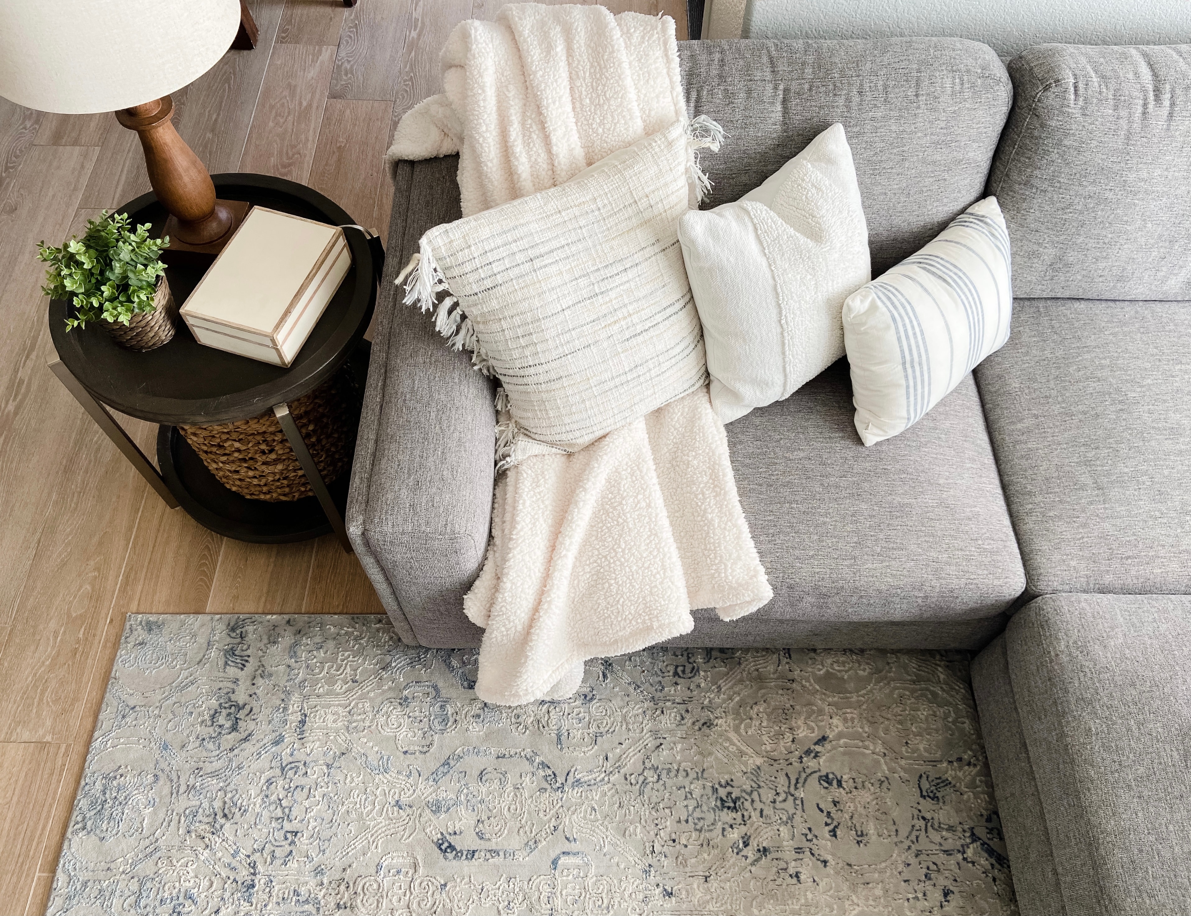 Living room with gray sofa and layered pillows